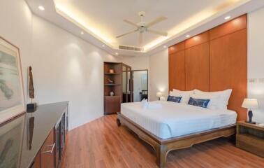 Spacious and modern bedroom with elegant wooden furniture and white bedding