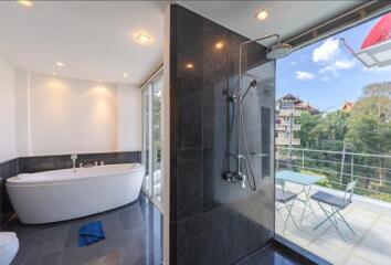 Modern bathroom with freestanding tub and outdoor access