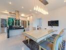 Modern kitchen with dining area featuring large table, designer chairs, and state-of-the-art appliances