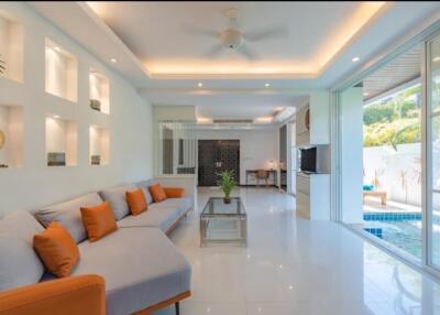 Bright and spacious living room with pool view