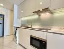 Modern kitchen with stainless steel appliances and white cabinetry