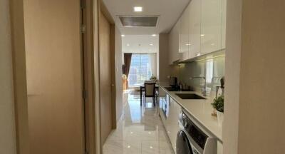 Modern kitchen with sleek design leading to a bright dining area