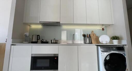 Modern kitchen interior with white cabinetry and stainless steel appliances