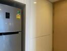 Compact entryway with modern refrigerator and secure door