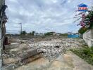 Wide open outdoor space with debris and cloudy sky