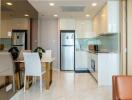 Modern kitchen with integrated dining area opening into a bright living space