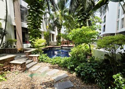 Lush garden with a swimming pool surrounded by tropical plants