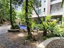 Lush garden courtyard with a pond in a modern residential building complex
