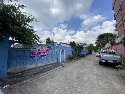 Exterior view of a property with a gated entrance and a parked car