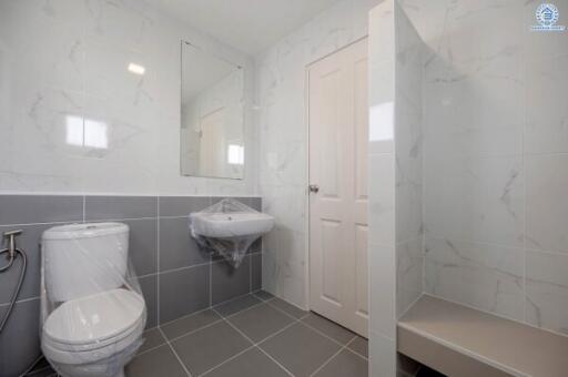 Clean and modern bathroom with grey tiles