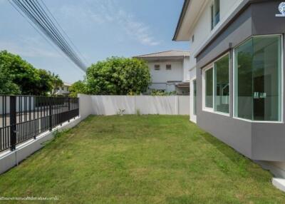 Spacious backyard garden with lawn and modern house exterior