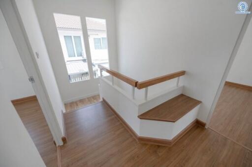 Bright interior space with wooden stairs leading to upper floor