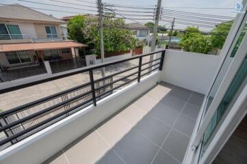 Spacious balcony overlooking the residential neighborhood