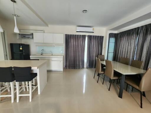 Spacious combined kitchen and dining area with modern furnishings