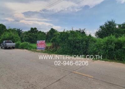 suburban road environment with real estate for sale sign