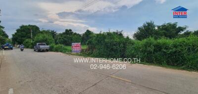 suburban road environment with real estate for sale sign