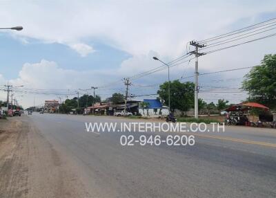 Street view outside the property showing road and neighborhood commercial area