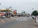 Busy urban street with various storefronts and vehicular traffic