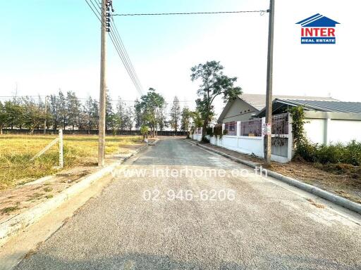 Quiet suburban street with modern homes and clear skies