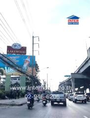 Busy urban street with traffic and real estate advertising