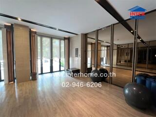 Spacious and modern living room with wooden floors and large windows