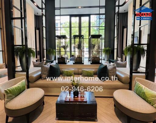 Elegant hotel lobby with comfortable seating and lush greenery