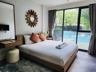 Spacious bedroom with pool view