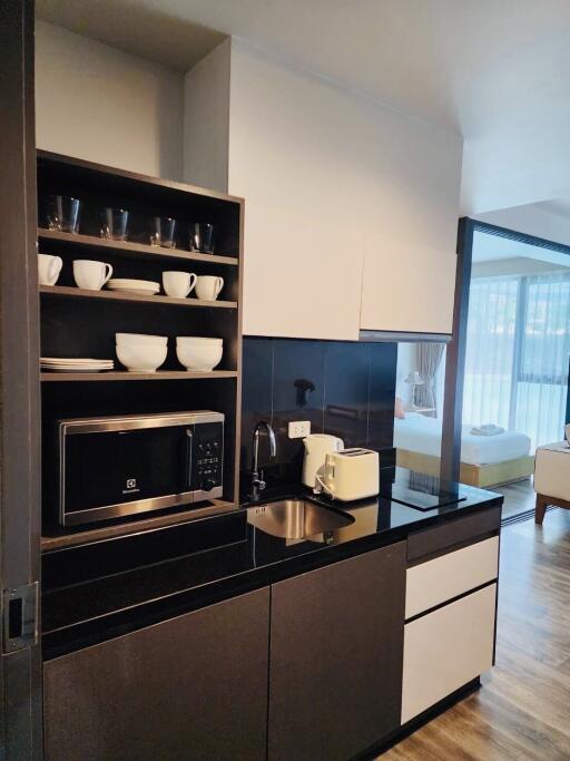 Modern kitchen with integrated appliances and open layout to the living room