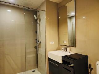 Modern bathroom with glass shower and sleek vanity