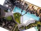 Aerial view of a residential complex with a centrally located swimming pool surrounded by apartment units