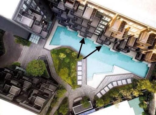 Aerial view of a residential complex with a centrally located swimming pool surrounded by apartment units