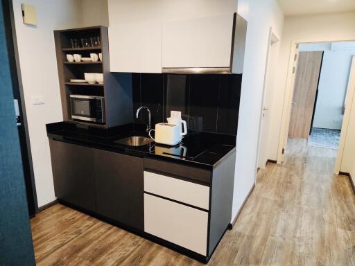 Modern kitchen with black countertops and integrated appliances