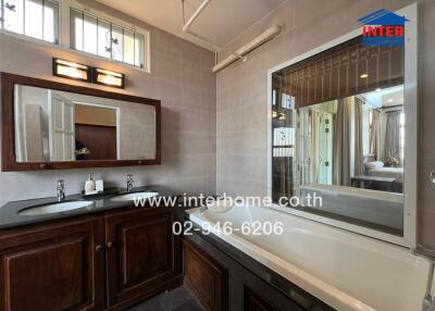 Spacious bathroom with modern amenities and wooden vanity