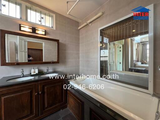 Spacious bathroom with modern amenities and wooden vanity