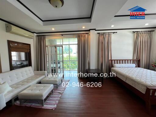 Spacious and bright living room with comfortable furniture and access to a balcony