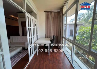 Spacious living room with large windows and white decor