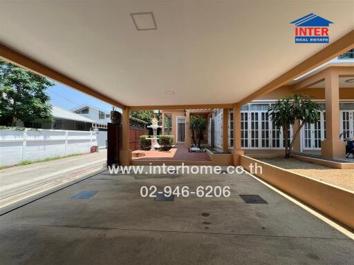 Spacious covered carport adjacent to a residential property
