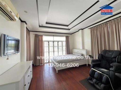 Spacious bedroom with modern amenities and ample natural light