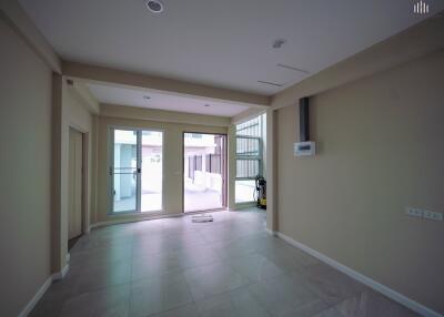 Spacious living room with large windows and sliding doors leading to the outside