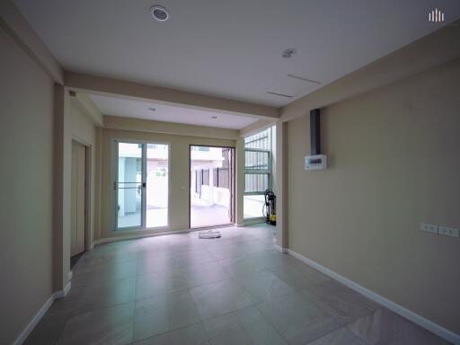 Spacious living room with large windows and sliding doors leading to the outside