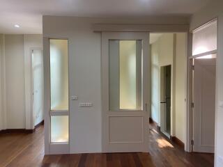 Hallway with wooden flooring and frosted glass doors