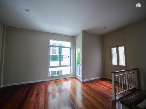 Spacious living room with wooden floors and large windows