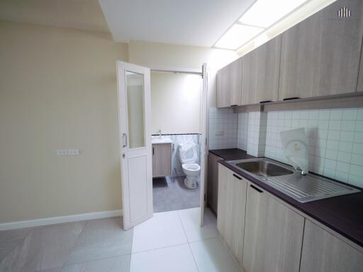 Modern kitchen with access to bathroom