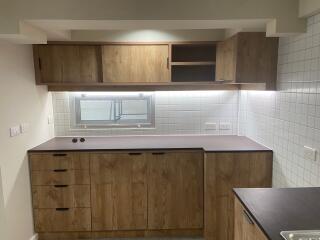 Modern kitchen with wooden cabinets and under-cabinet lighting