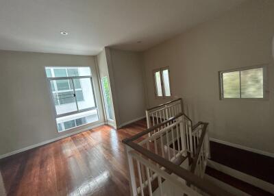 spacious living area with large windows and wooden flooring