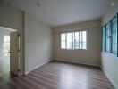 Bright living room with wood flooring and large windows