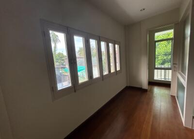 Spacious hallway with large windows and wooden flooring