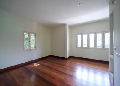 Spacious living room with large windows and wooden floor