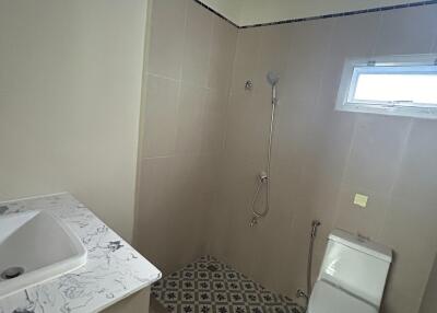 Modern bathroom with patterned floor tiles and shower