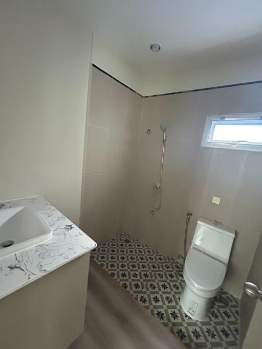 Modern bathroom with patterned floor tiles and shower